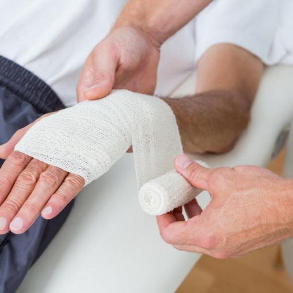 doctor-bandaging-his-patient-hand